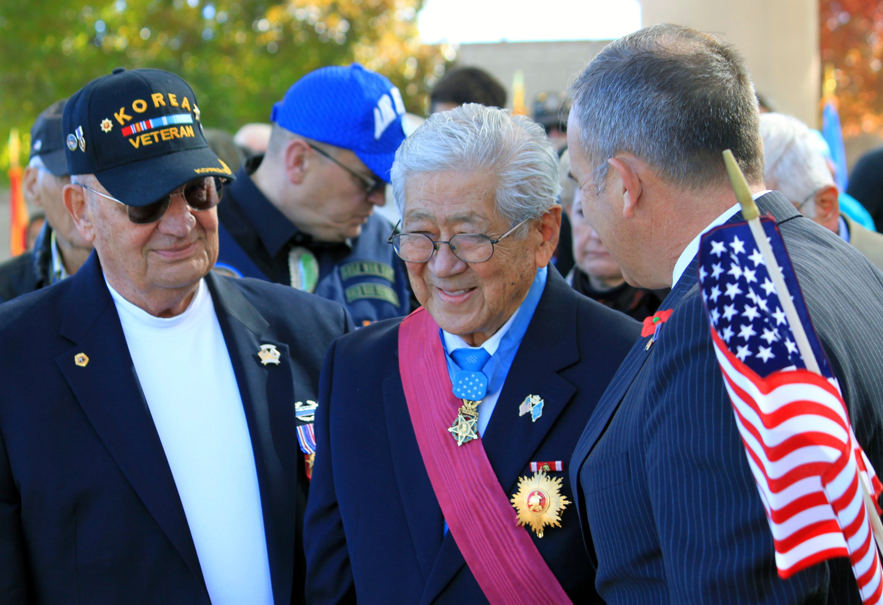 People stand to honor Medal of Honor recipient Hiroshi Miyamura, center, during a Veterans Day ceremony at the New Mexico Veterans Memorial in Albuquerque, N.M., on Nov. 11, 2014.