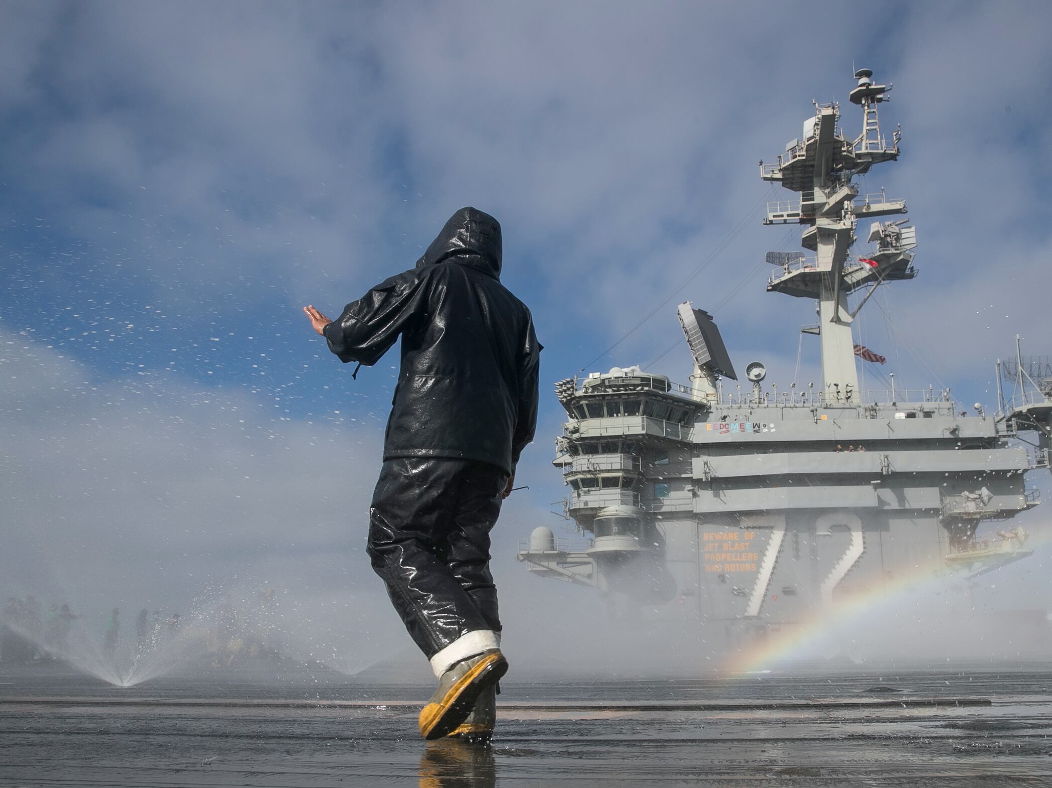 Aviation Boatswain's Mate (Handling) Airman Michael Meneses inspects the flight deck's countermeasure wash-down sprinklers on the aircraft carrier USS Abraham Lincoln (CVN 72) on May 16, 2020, in the Pacific Ocean.