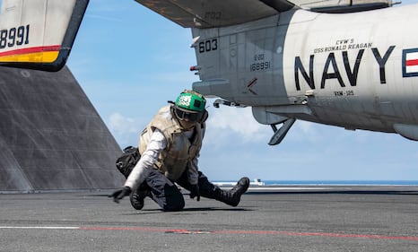 Aviation Machinist’s Mate 3rd Class Brandee Robinson conducts final checks on an E-2D Hawkeye as it prepares to launch from the flight deck of the aircraft carrier USS Ronald Reagan (CVN 76) on Aug. 2, 2020, in the Pacific Ocean.