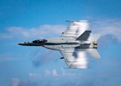 Lt. Cmdr. Benjamin Orloff conducts a supersonic pass in a F/A-18E Super Hornet on Aug. 23, 2019, next to the guided-missile destroyer USS Gridley (DDG 101) during a training exercise in the Atlantic Ocean.