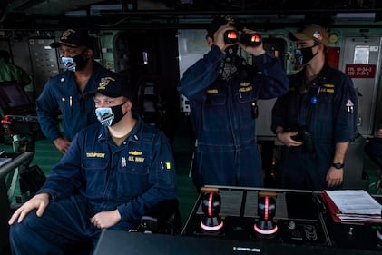 Sailors stand watch on the navigation bridge aboard the Freedom-variant littoral combat ship USS Detroit (LCS 7) as the ship pulls into Colon, Panama, on May 19, 2020, for stores and fuel.