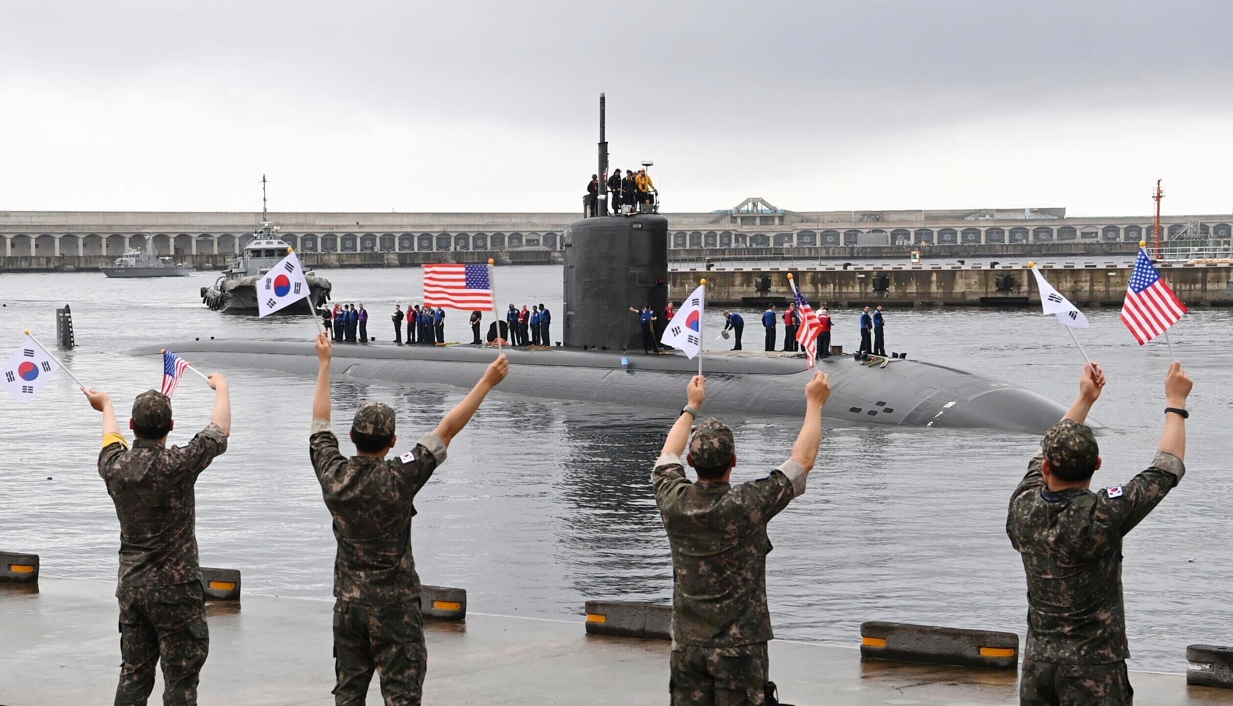 In this photo provided by South Korea Defense Ministry, South Korean navy sailors wave as the U.S. nuclear-powered submarine Annapolis arrives at a South Korean naval base on Jeju Island, South Korea, Monday, July 24, 2023.