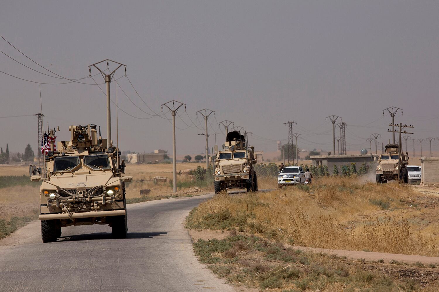 U.S. armored vehicles travel in a joint patrol of the safe zone between Syria and the Turkish border with the Tal Abyad Military Council Tal Abyad, Syria, Friday, Sept. 6, 2019.