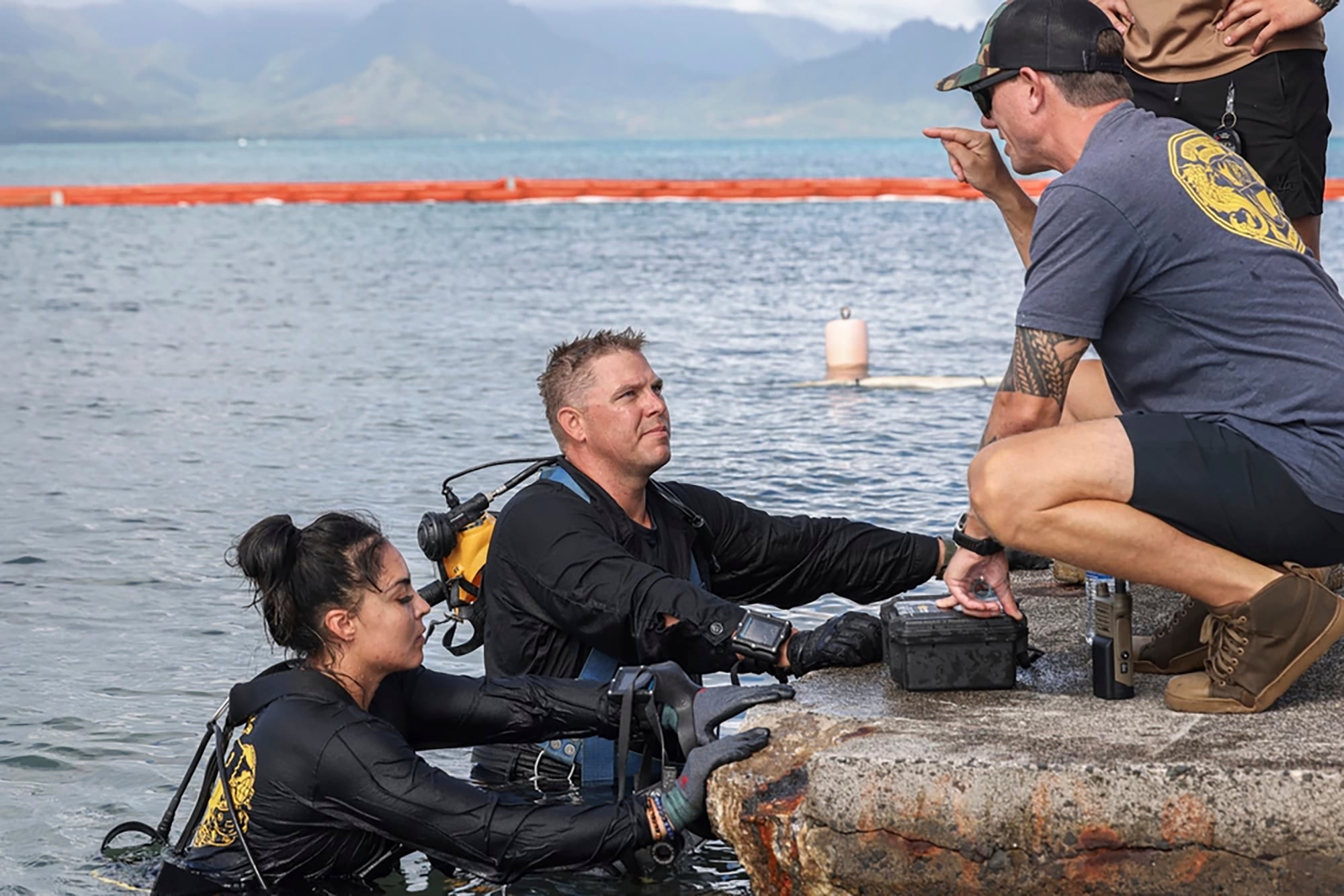 In this photo provided by U.S. Marine Corps, U.S. Navy sailors, retrieved the aircraft flight recorder from a downed U.S. Navy P-8A Poseidon and are debriefed in waters just off the runway at Marine Corps Air Station Kaneohe Bay, Marine Corps Base Hawaii, Thursday, Nov. 23, 2023.