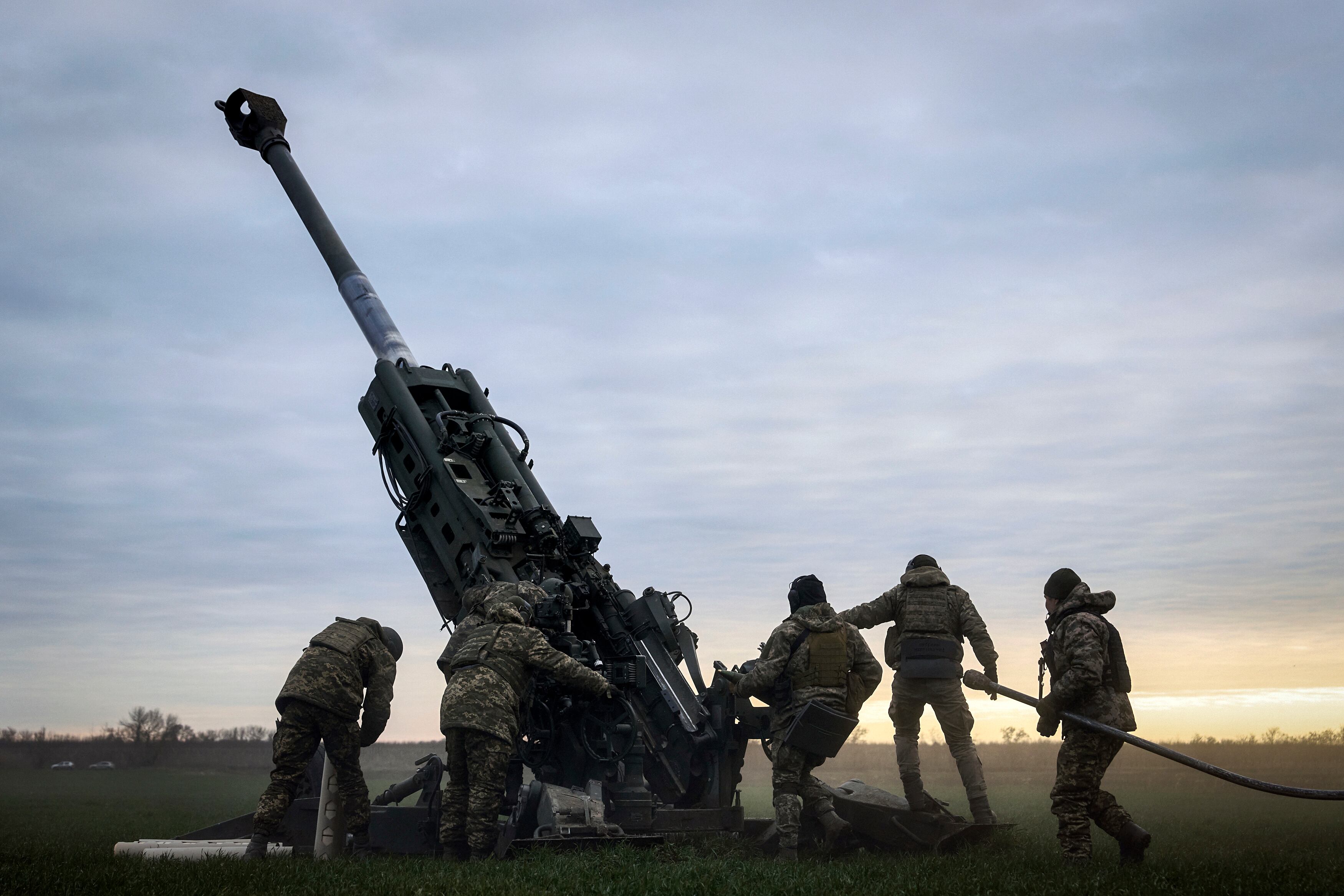 Ukrainian soldiers prepare a U.S.-supplied M777 howitzer to fire at Russian positions in Kherson region, Ukraine, Jan. 9, 2023.