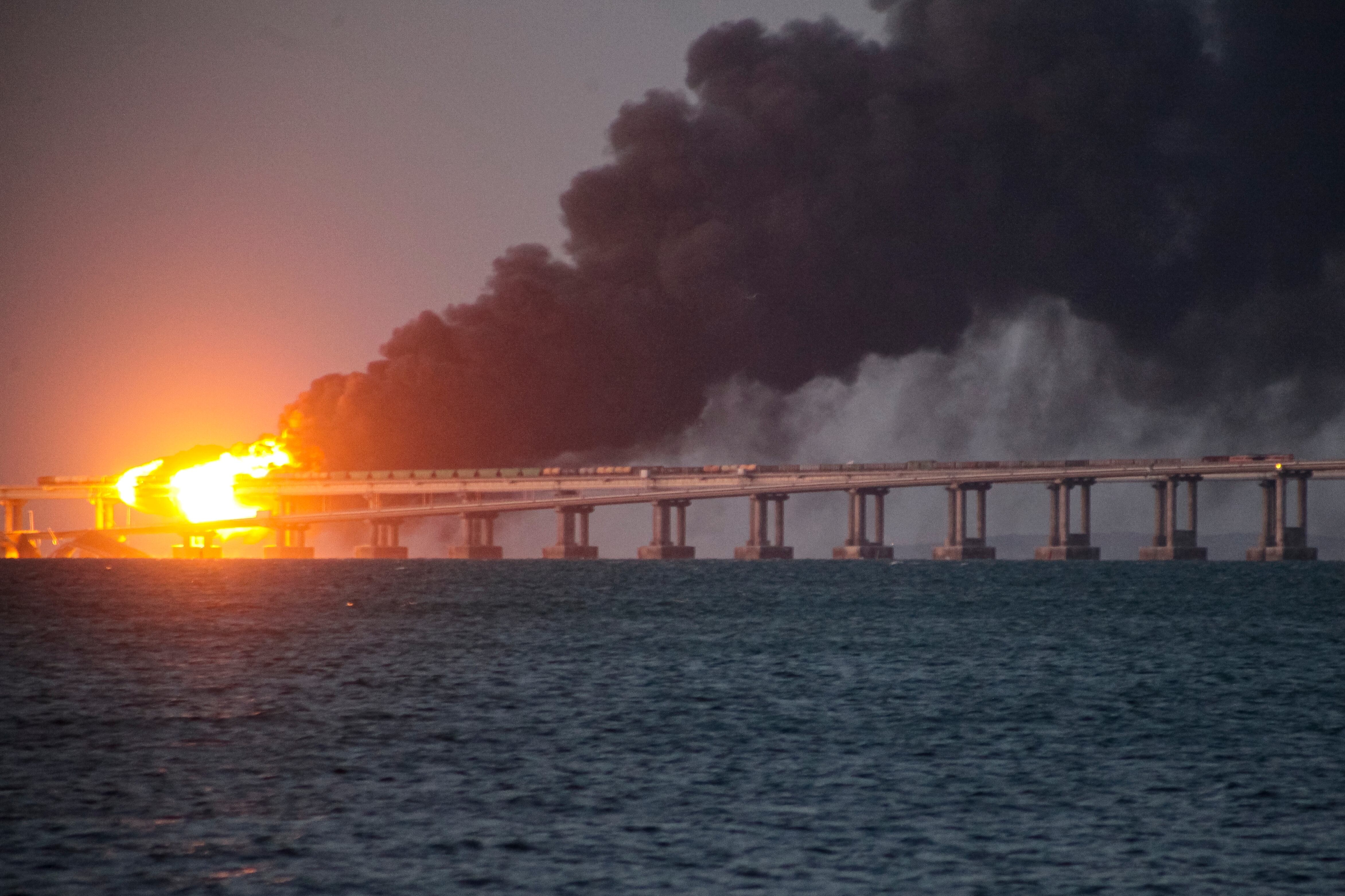 Flame and smoke rise from Crimean Bridge connecting Russian mainland and Crimean peninsula over the Kerch Strait, in Kerch, Crimea, Saturday, Oct. 8, 2022.