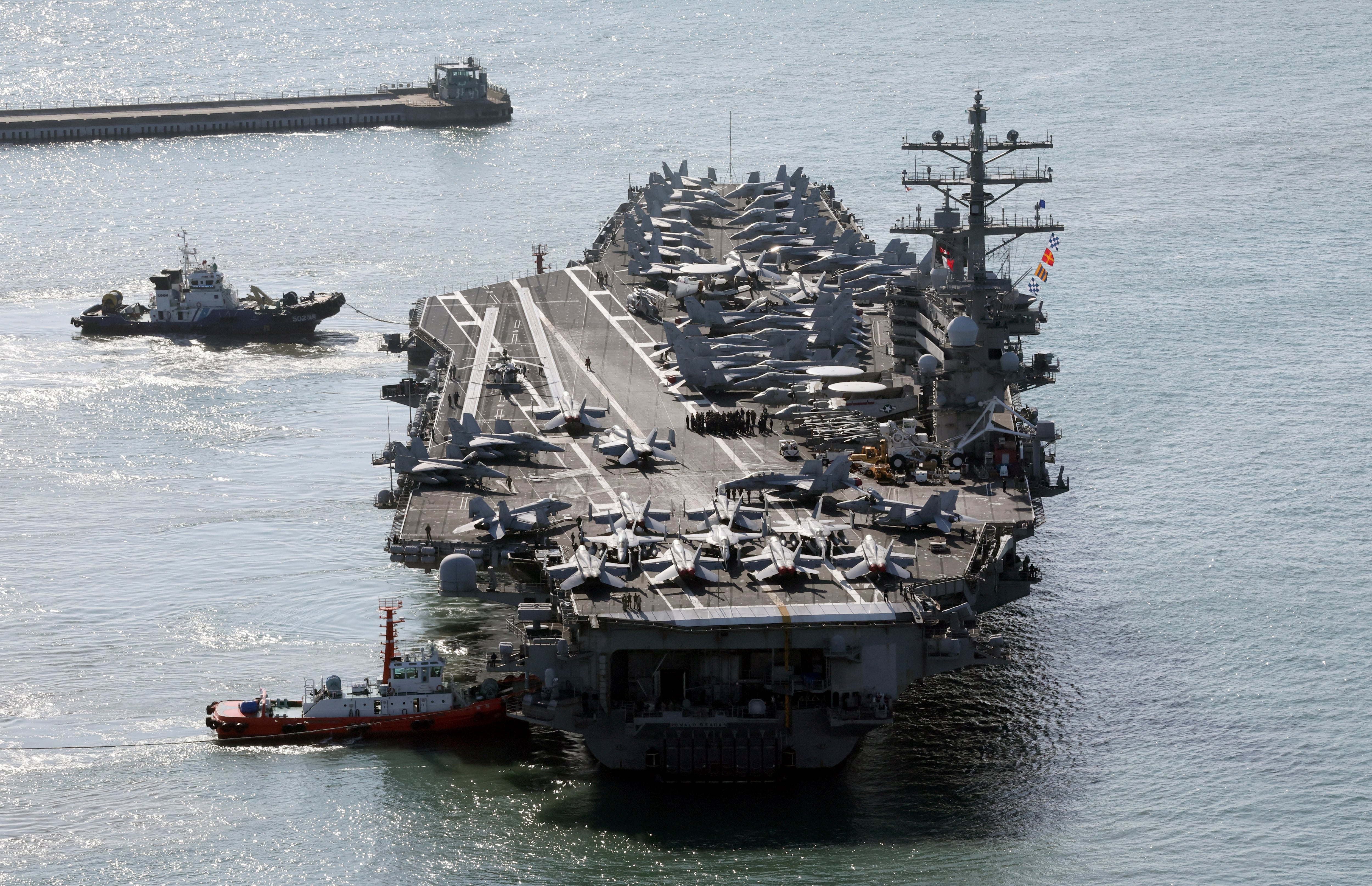 U.S. nuclear-powered aircraft carrier Ronald Reagan is escorted as it arrives in Busan, South Korea, Thursday, Oct. 12, 2023.