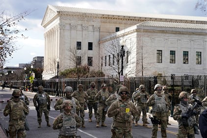 Members of the National Guard stand at a road block near the Supreme Court ahead of President-elect Joe Biden's inauguration ceremony, Wednesday, Jan. 20, 2021, in Washington.