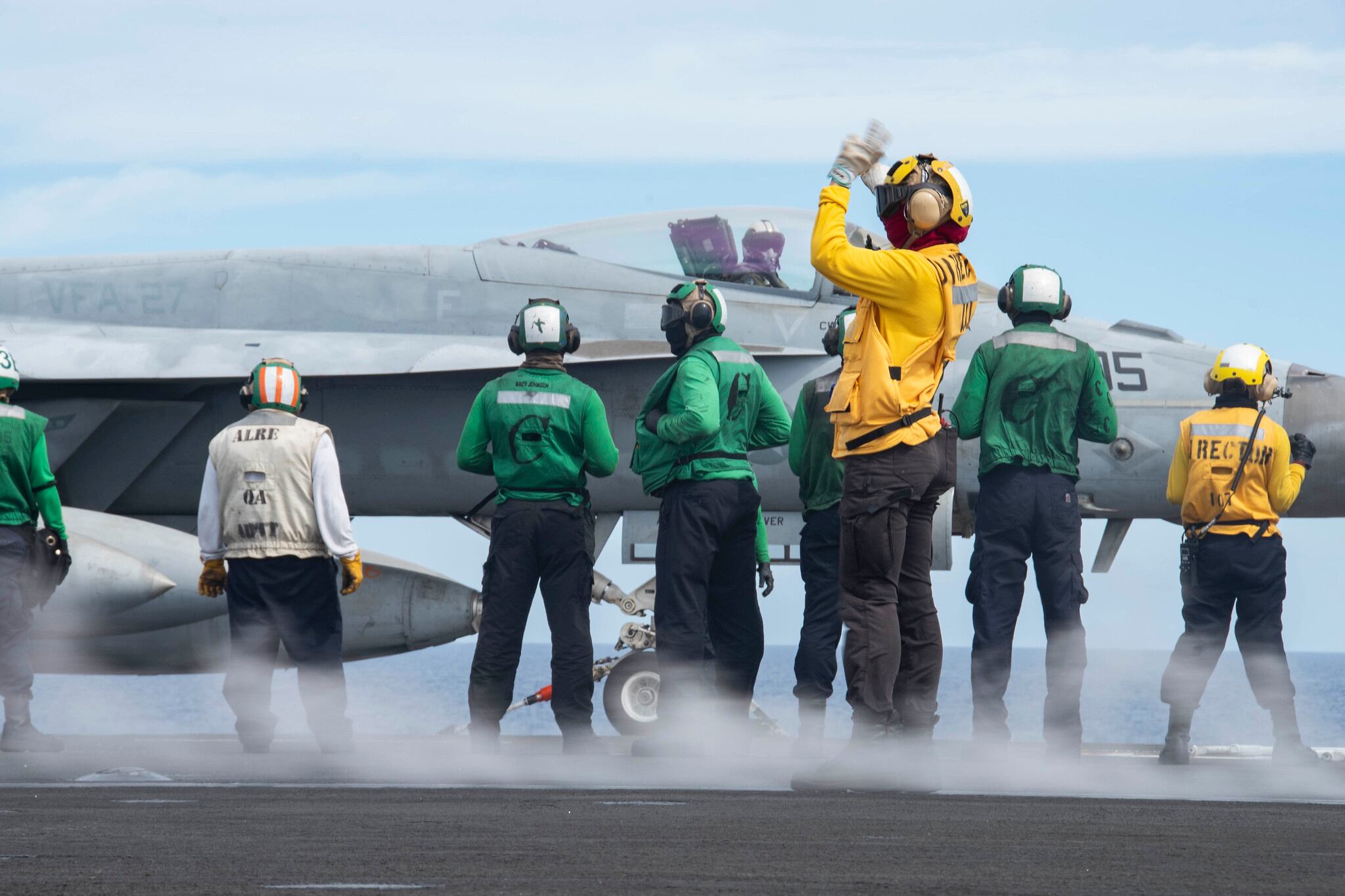 Sailors prepare to launch an F/A-18E Super Hornet on the flight deck of the aircraft carrier USS Ronald Reagan (CVN 76) on June 18, 2020, during flight operations in the Philippine Sea.