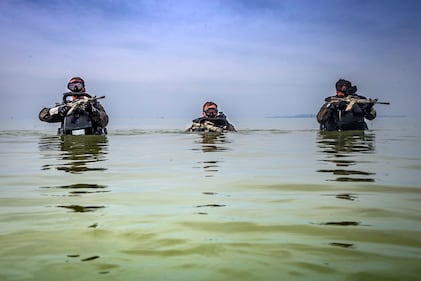 U.S. Marines patrol through water during a Marine Corps Combat Diving Supervisors Course on Camp Schwab, Okinawa, Japan, May 20, 2020.