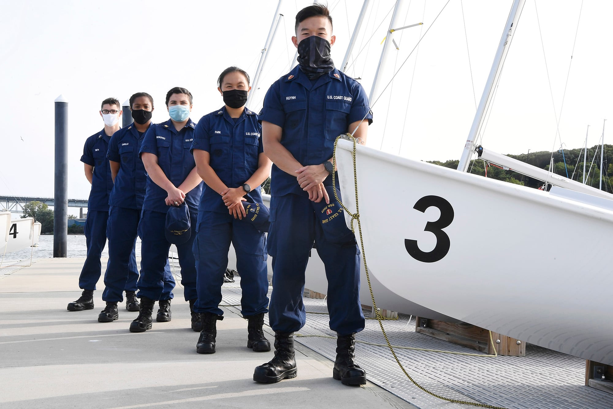 From back left: Coast Guard Academy cadets Henry Smith, Branyelle Carillo, Mia Haskovec, Jordan Park, and Tyler Huynh, pose for a photograph on Sept. 14, 2020, at the Seamanship Sailing Center at the United State Coast Guard Academy in New London, Conn.