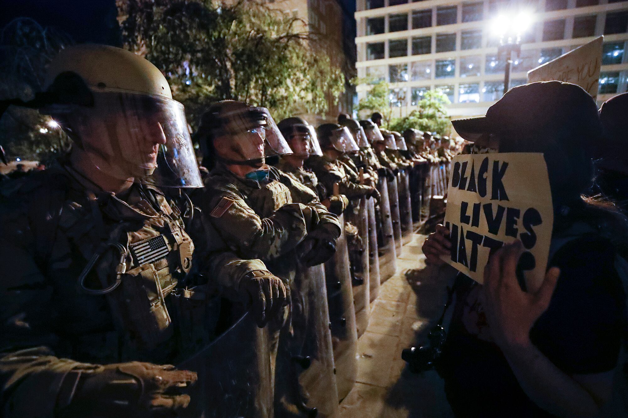 Utah National Guard soldiers line the street as demonstrators gather to protest the death of George Floyd, Wednesday, June 3, 2020, near the White House in Washington.