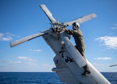 Lt. Austin Gallegos verifies tail rotor integrity on a MH-60R Sea Hawk on July 19, 2019, aboard the Ticonderoga-class guided-missile cruiser USS Chancellorsville (CG 62) in the Coral Sea.