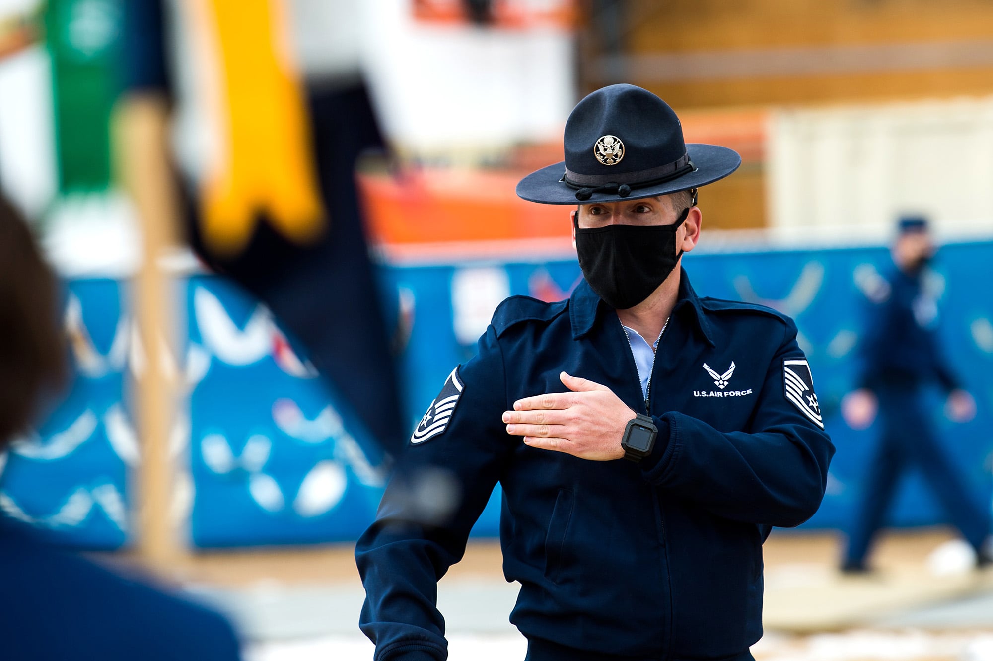 Master Sgt. Adam Antonioli, a military training instructor, demonstrates proper form to cadet guidon bearers during drill and ceremonies training, Feb. 1, 2021, at the U.S. Air Force Academy in Colorado Springs, Colo.