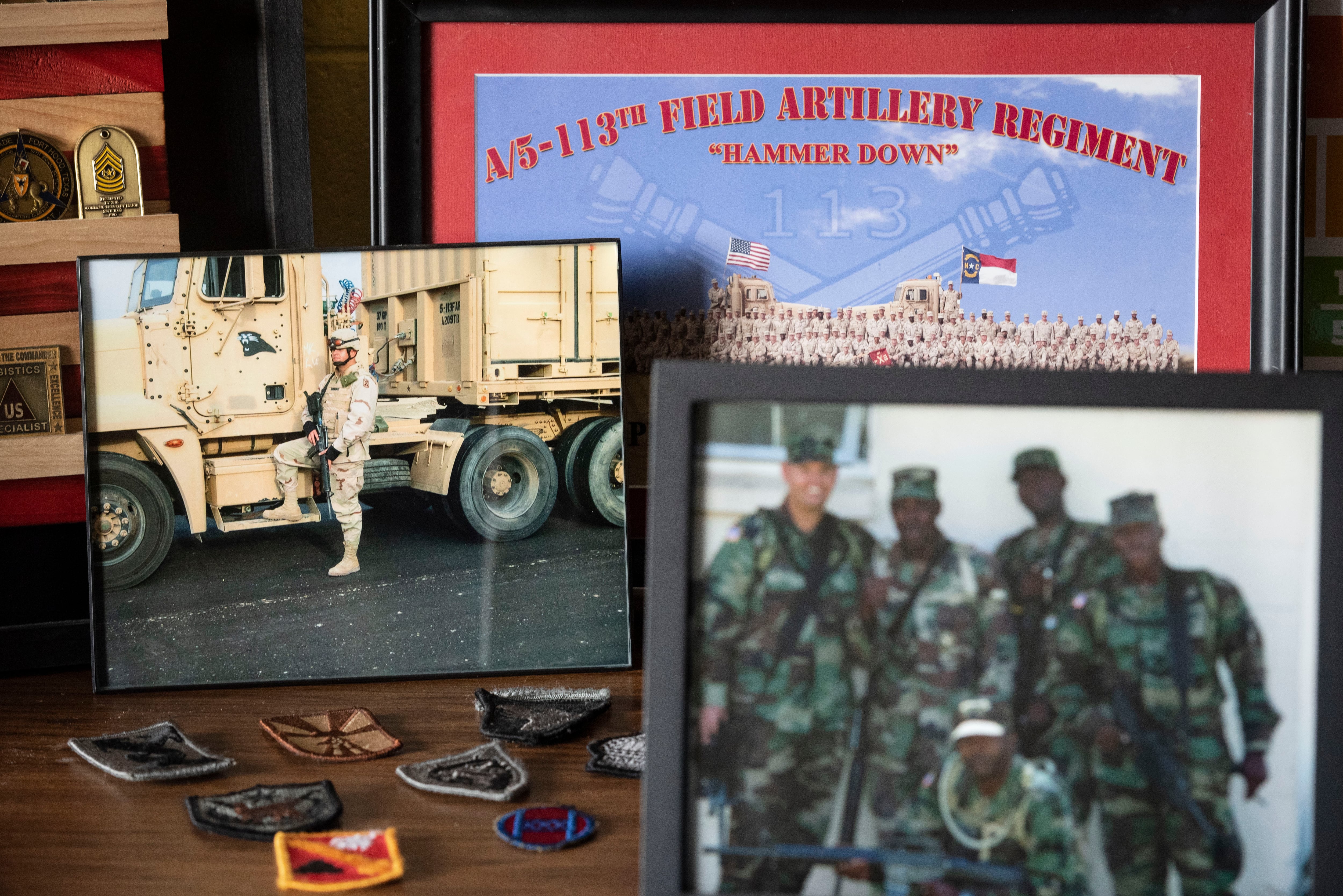 Various photos of Christopher Simmons while he served in the Army are displayed on a desk on Thursday, Oct. 27, 2022, at Meadowlark Middle School in Winston-Salem, N.C.