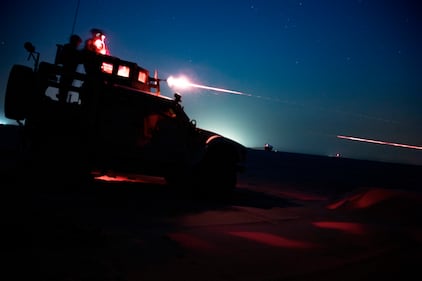 U.S. Marines fire an M240B from an MRAP All-Terrain Vehicle during night time machinegun range in Kuwait, June 16, 2020.