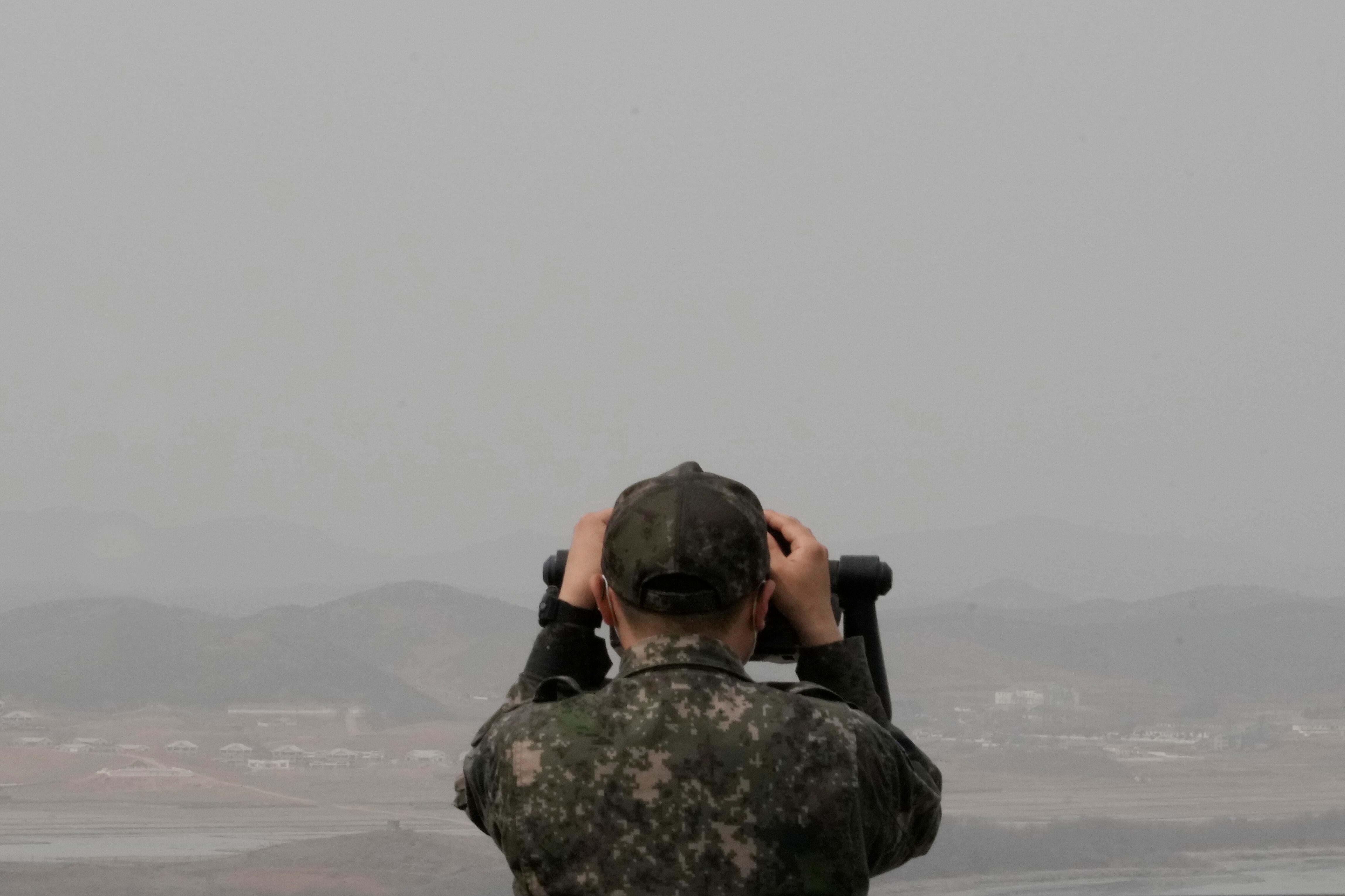 A South Korean army soldier watches the North Korea side from the Unification Observation Post in Paju, South Korea, near the border with North Korea, Friday, March 24, 2023.