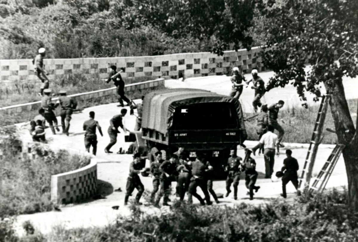 In this Aug. 18, 1976, file photo, North Korean soldiers attack United Nations Command personnel wearing helmets at the truce village of Panmunjom, South Korea.