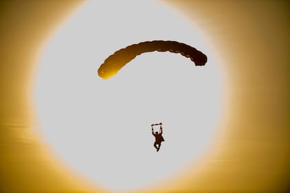 U.S. Army Reserve and active duty soldiers perform an airborne operations jump from UH-60 Black Hawk helicopters at Fort Bragg, N.C., July 17, 2020.