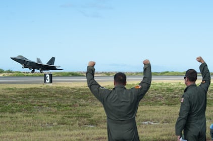 Hawaii Air National Guard pilots cheer on an F-22 Raptor at Joint Base Pearl Harbor-Hickam, Hawaii, on Aug. 21, 2019.