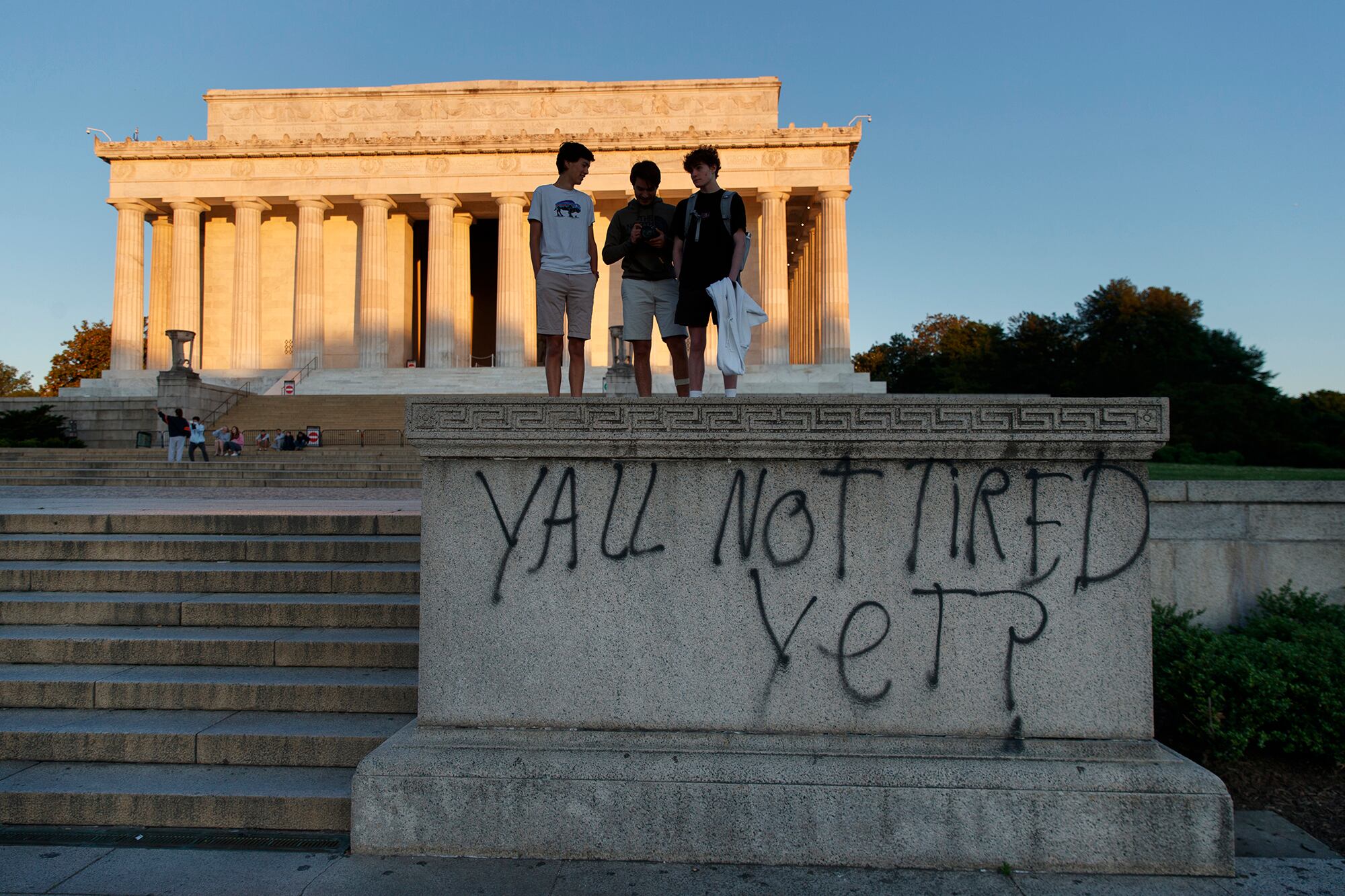 Spray paint that reads "Yall Not Tired Yet?" is seen on the base of the Lincoln Memorial on the National Mall in Washington, early Sunday, May 31, 2020, the morning after protests over the death of George Floyd.