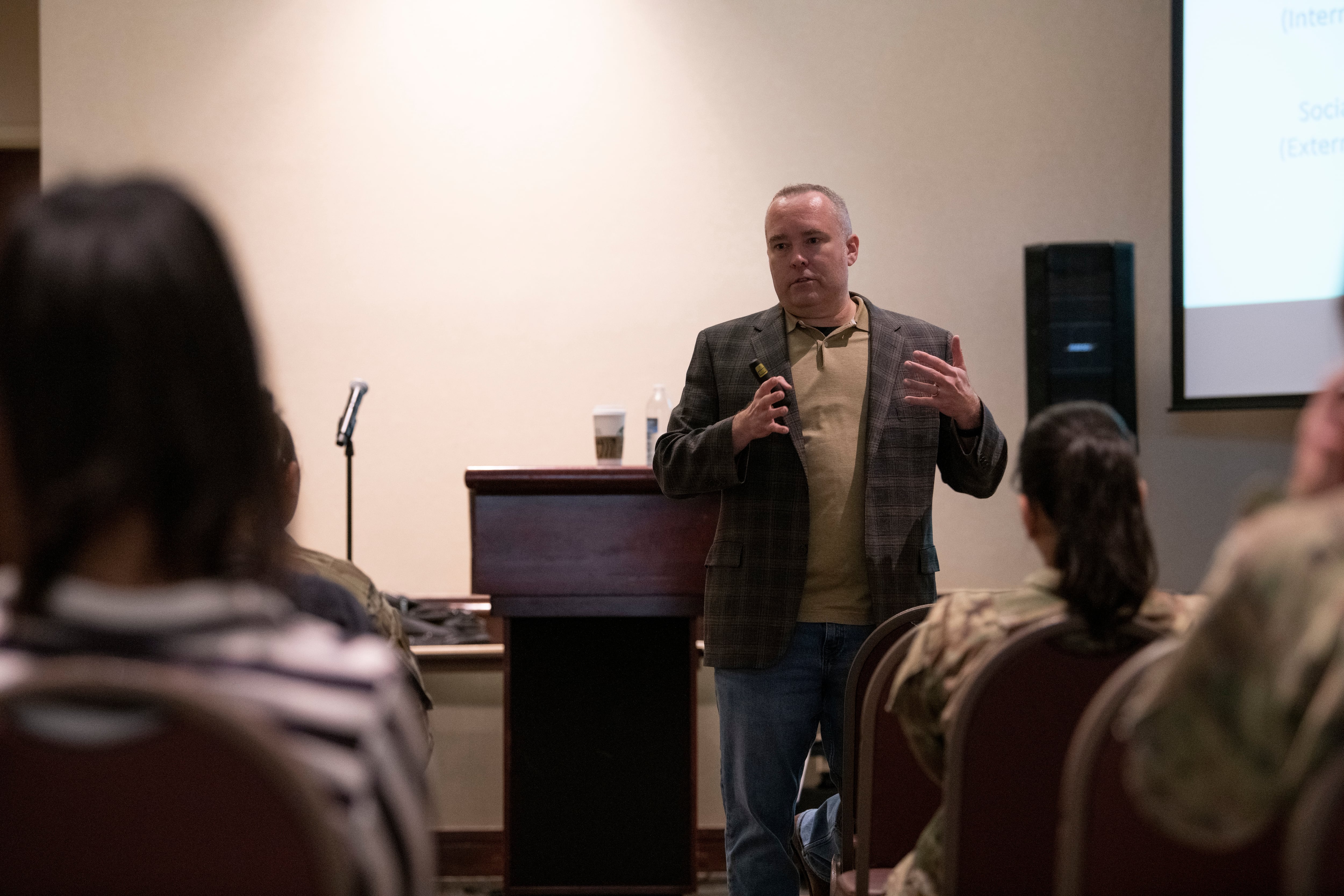 Psychologist Craig Bryan speaks to a room of David Grant USAF Medical Center mental health care providers at Travis Air Force Base, California, in 2022.