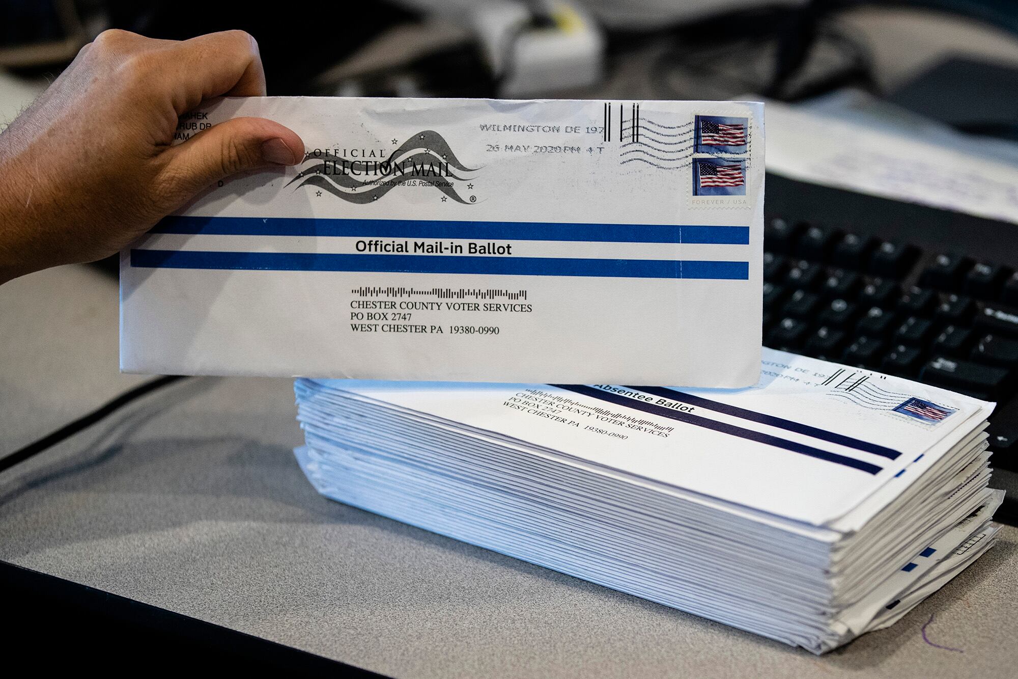 In this May 28, 2020, file photo, mail-in primary election ballots are processed at the Chester County Voter Services office in West Chester, Pa.