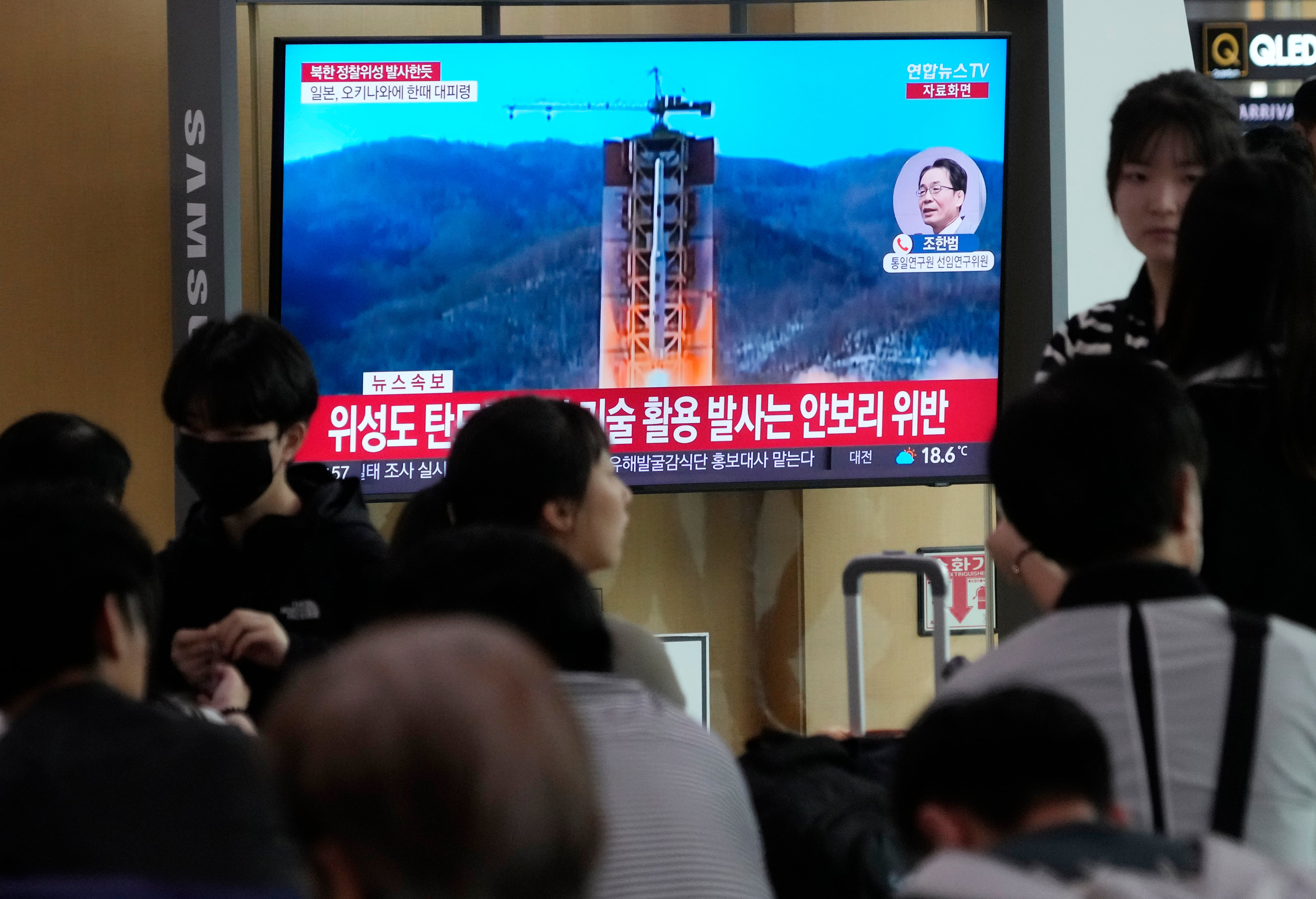 A TV screen shows a file image of North Korea's rocket launch during a news program at the Seoul Railway Station in Seoul, South Korea, Wednesday, May 31, 2023.