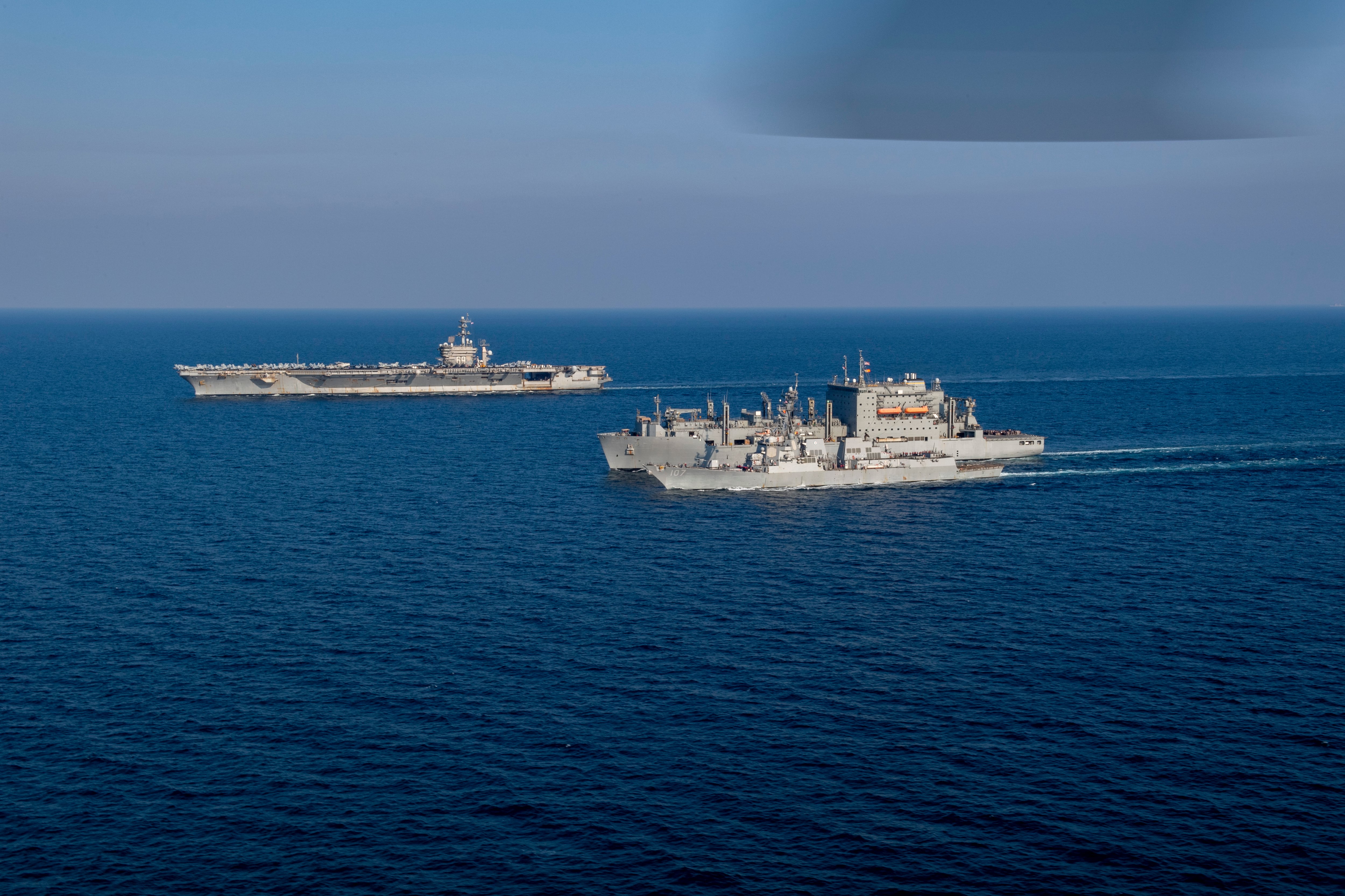 The aircraft carrier Dwight D. Eisenhower, the dry cargo ship USNS Alan Shepard and the guided-missile destroyer Gravely conduct a replenishment-at-sea in the Arabian Gulf, Dec. 8, 2023.