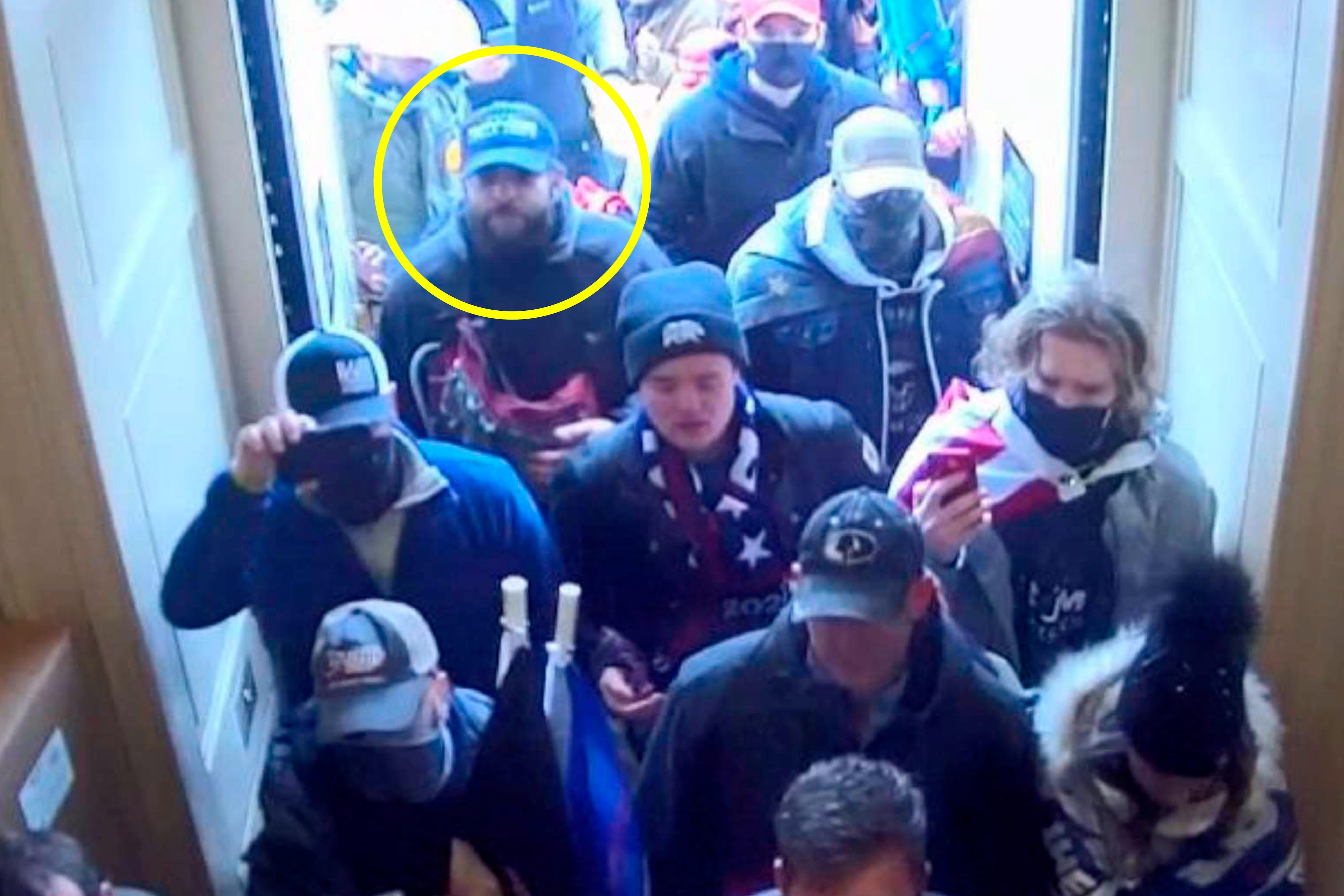 In this image from U.S. Capitol Police security video, released and annotated by the Justice Department in the Statement of Facts supporting an arrest warrant, Taylor Taranto, circled in yellow, enters the U.S. Capitol through the Upper West Terrace door on Jan. 6, 2021, in Washington