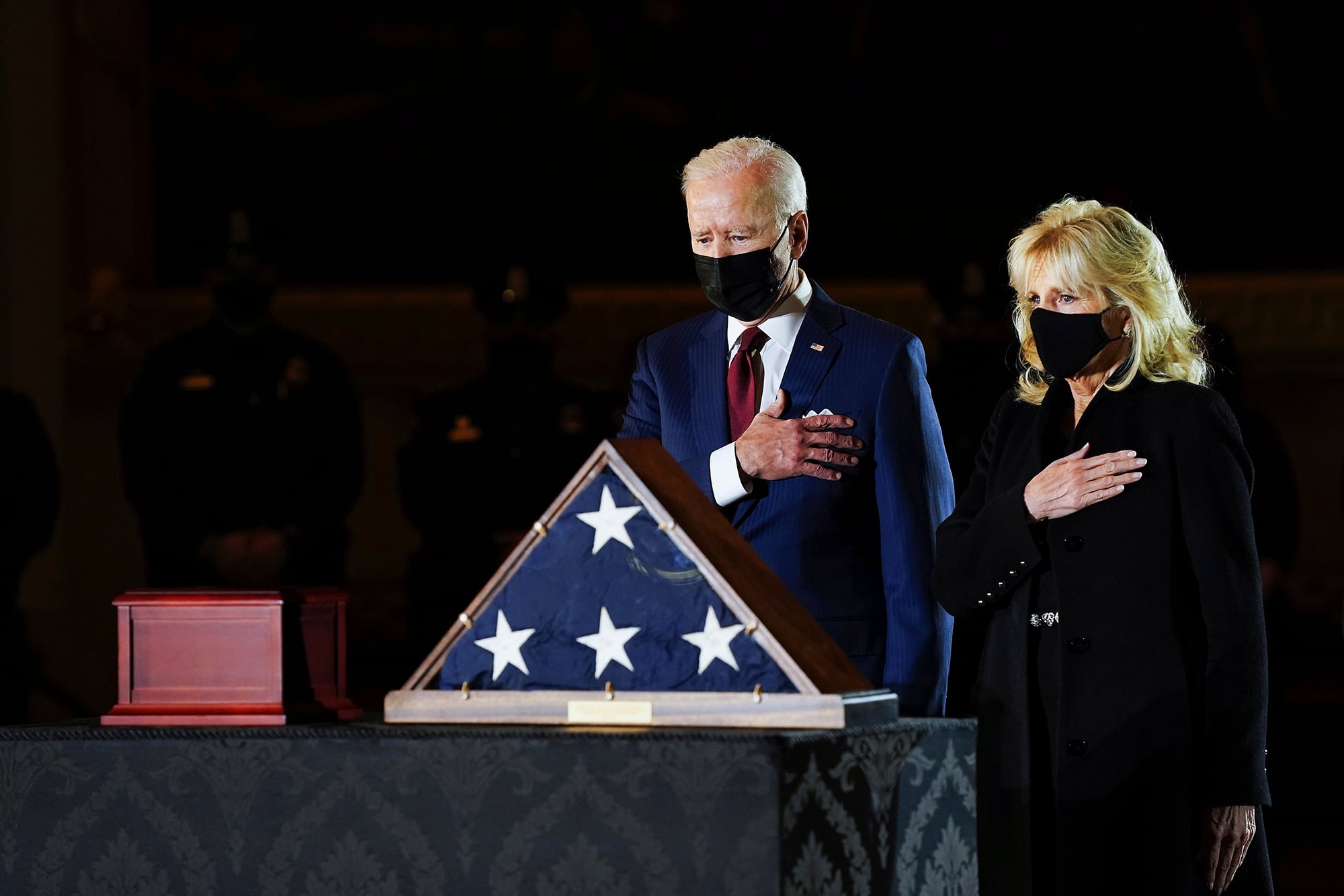 President Joe Biden and first lady Jill Biden pay their respects to the late U.S. Capitol Police officer Brian Sicknick as an urn with his cremated remains lies in honor on a black-draped table at center of Capitol Rotunda, Tuesday, Feb. 2, 2021, in Washington.