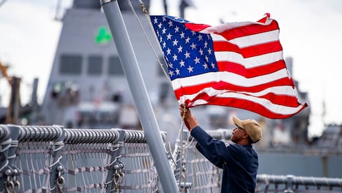 A sailor assigned to the Freedom-class variant littoral combat ship USS Billings (LCS 15) lowers the American flag Aug. 30, 2019, as the ship get underway from Naval Station Mayport.