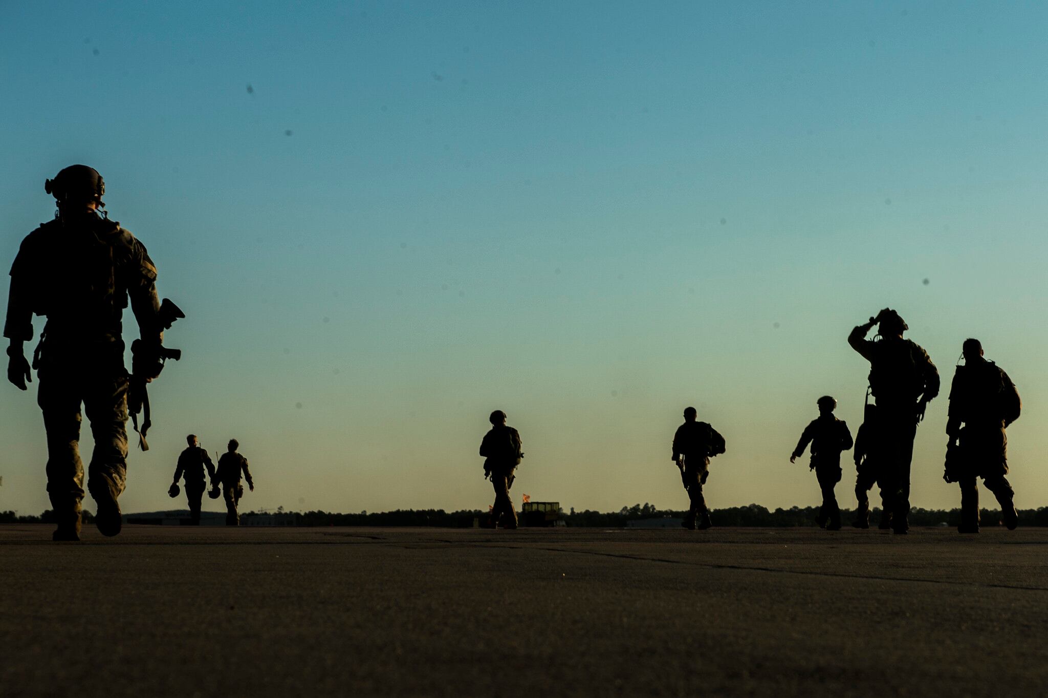 U.S. soldiers with the 20th Special Forces Group walk on a flight line in Gulfport, Miss., May 5, 2014, during Emerald Warrior 2014, a U.S. Special Operations Command-sponsored exercise designed to provide realistic military training in an urban setting.