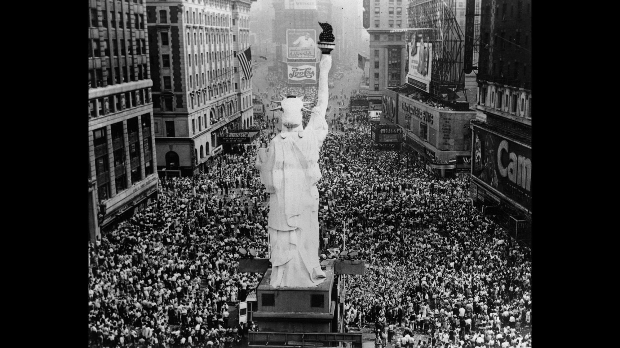 Crowds cheer in Times Square as President Truman announces the formal signing of the Japanese Instrument of Surrender at the end of World War II, Sept. 2, 1945.