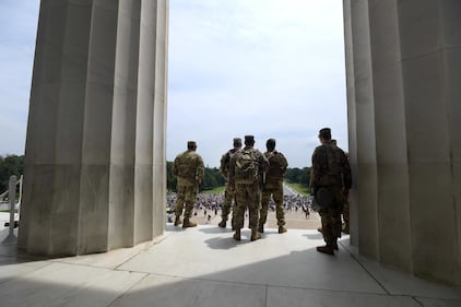 Soldiers with the Mississippi Army National Guard's 1st Battalion, 155th Infantry Regiment watch from the Lincoln Memorial as demonstrators peacefully gather in front of the memorial during protests in Washington, D.C., Saturday, June 6, 2020, in the wake of the death of George Floyd.