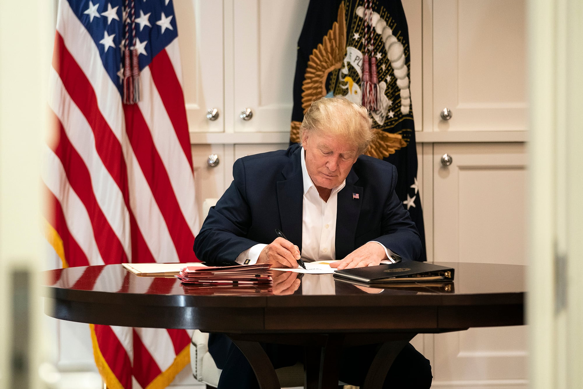 President Donald Trump works in the Presidential Suite at Walter Reed National Military Medical Center in Bethesda, Md., Saturday, Oct. 3, 2020, after testing positive for COVID-19.