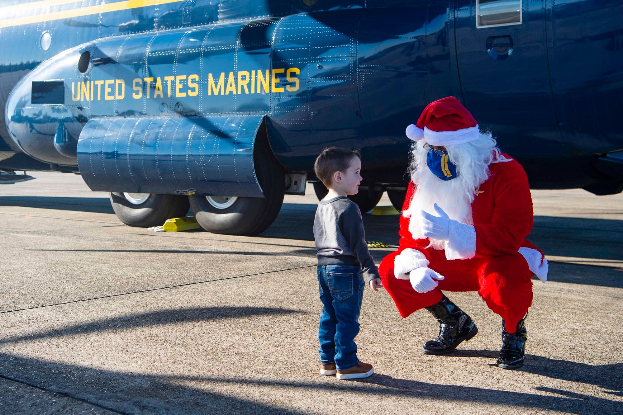 Santa speaks with a child while joining the Blue Angels, the Navy’s flight demonstration squadron, to support the Marine Corps Toys for Tots program by delivering toys and games to families impacted by the COVID-19 pandemic and multiple hurricanes in Lake Charles, La., Dec. 8, 2020.