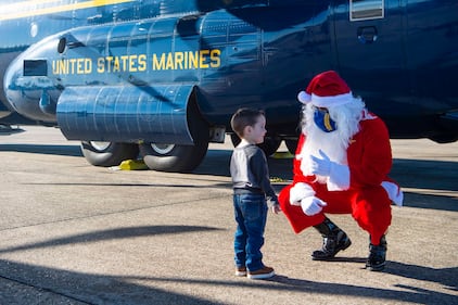 Santa speaks with a child while joining the Blue Angels, the Navy’s flight demonstration squadron, to support the Marine Corps Toys for Tots program by delivering toys and games to families impacted by the COVID-19 pandemic and multiple hurricanes in Lake Charles, La., Dec. 8, 2020.