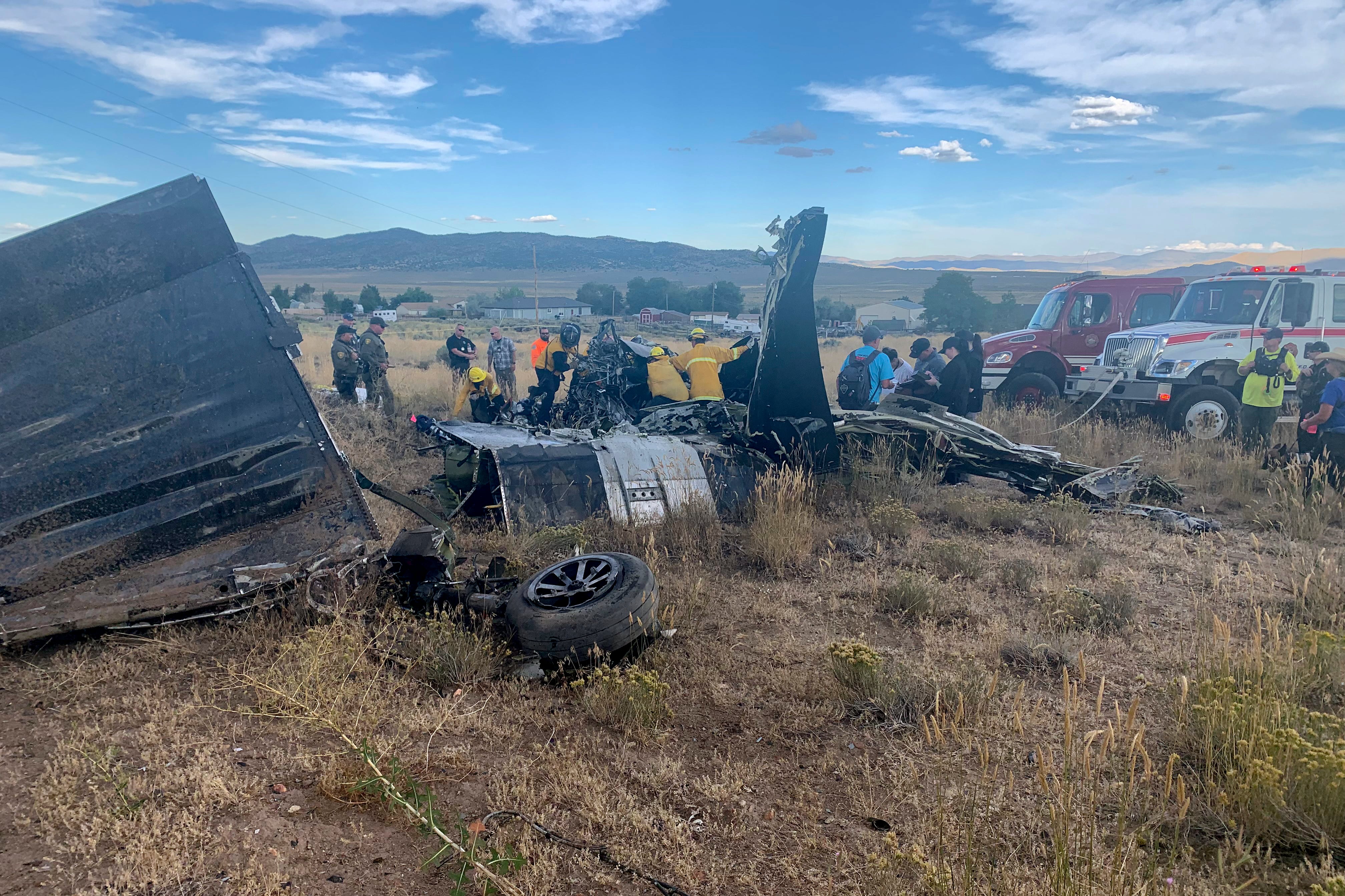 CORRECTS AND CLARIFIES NAME AND LOCATION OF TRUCKEE FIRE & RESCUE - FILE - In this photo provided by Truckee Meadows Fire & Rescue, in Reno, Nev., members of Truckee Meadows Fire & Rescue and other officials look over aircraft wreckage, Sunday, Sept. 17, 2023, in Reno, after two California pilots were killed when their planes collided in mid-air while preparing to land after completing a race at the National Championship Air Races north of the city. Aviation experts say that for whatever reason, at least one racing pilot apparently didn’t see the other when their vintage planes collided in mid-air while preparing to land after finishing first and second at the air races the previous weekend. Federal investigators expect to release a preliminary report in another week or so. (Adam R. Mayberry/Truckee Meadows Fire & Rescue via AP, File)