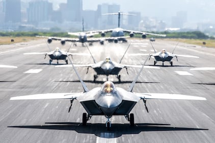 F-22 Raptors, a KC-135 Stratotanker and a C-17 Globemaster III taxi on the runway during a routine training schedule April 21, 2020, at Honolulu International Airport