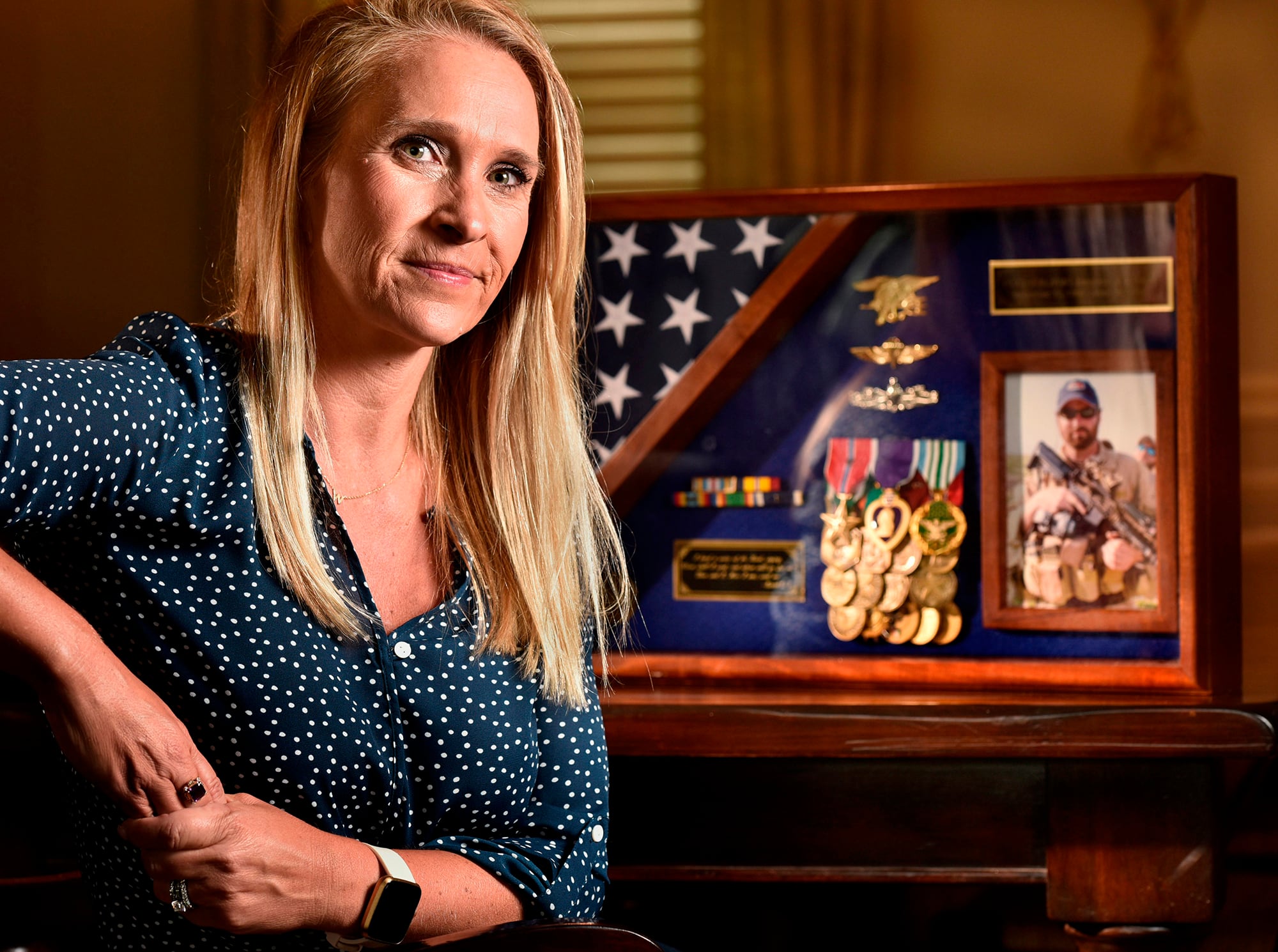 Char Fontan Westfall poses with a memorial of her late husband Jacques Fontan, at her home on  June 25, 2020, in St. Johns, Fla.