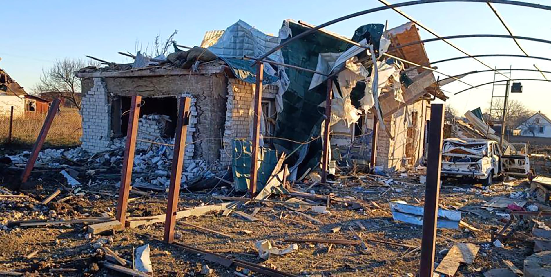 In this photo provided by the Zaporizhzhia region military administration, a damaged building and a car are seen after a Russian strike in the village of Novosofiivka, in the Zaporizhzhia region, Ukraine, Monday, Dec. 5, 2022.