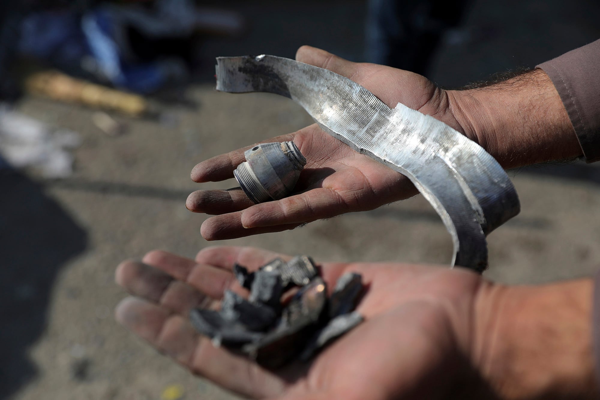 An Afghan man holds rocket shell after a rocket attack in Kabul, Afghanistan, Saturday, Nov. 21, 2020.