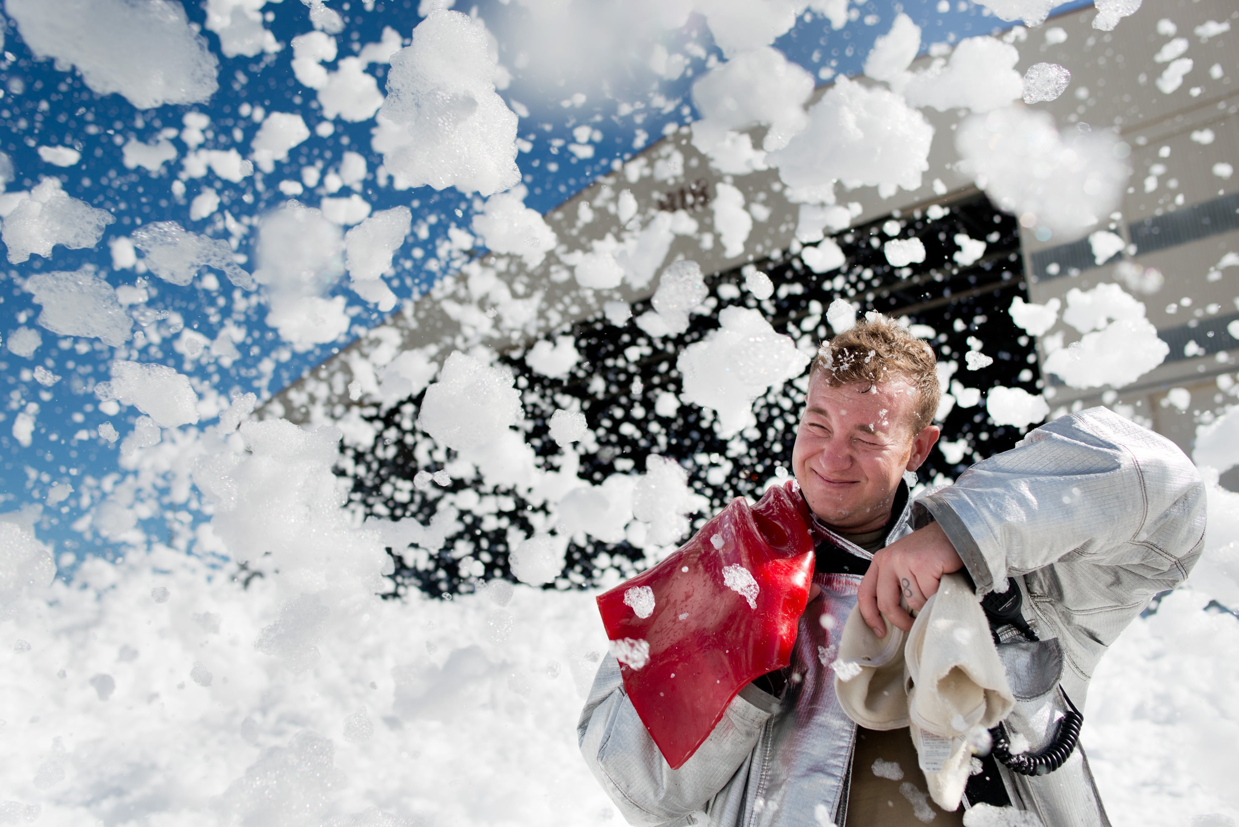 John Sherman, a 60th Engineer Squadron firefighter, is hit by fire-retardant foam after it was “unintentionally released” in an aircraft hangar at Travis Air Force Base in California on Sept. 24, 2013.