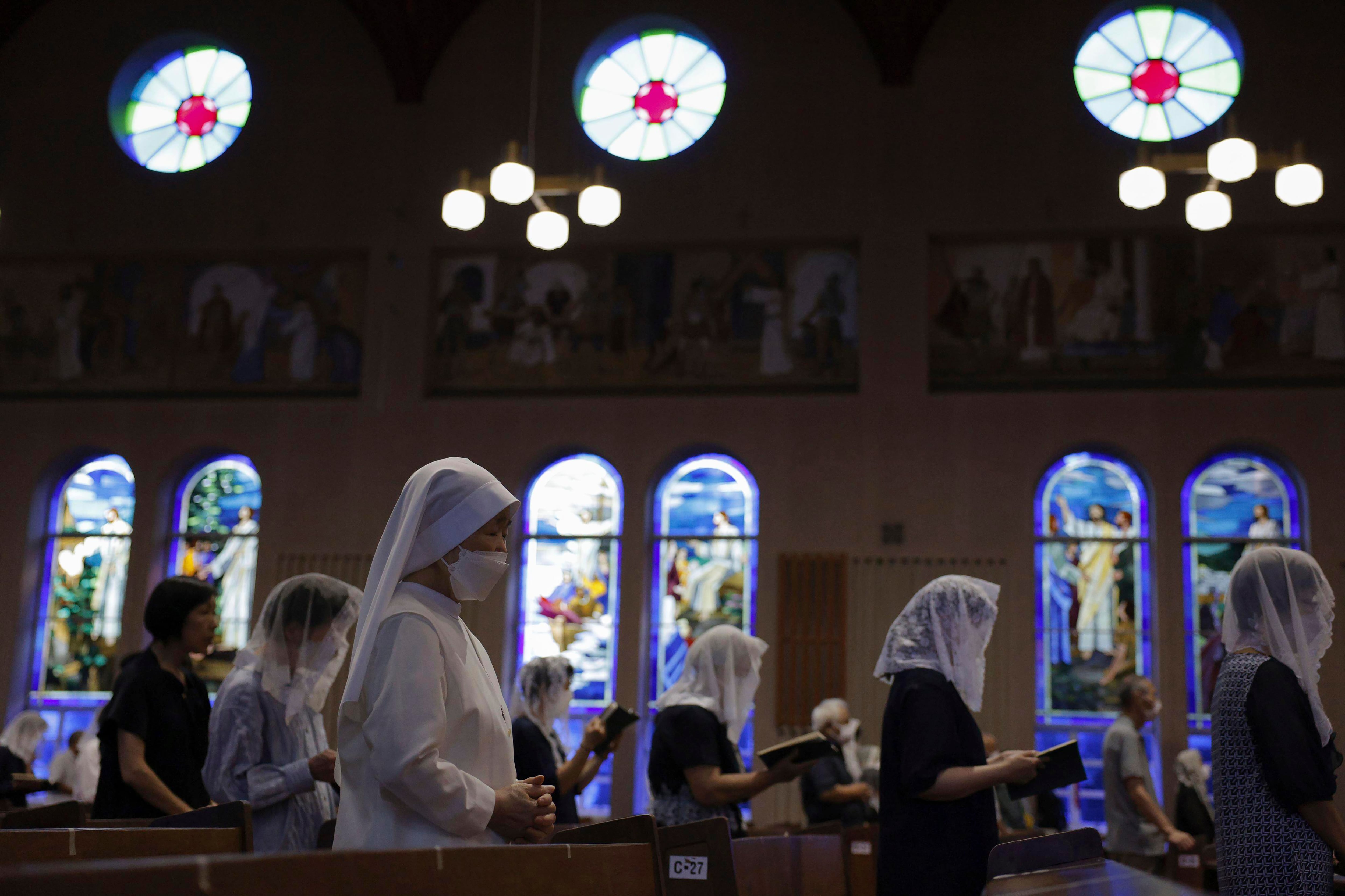 People attend an early morning Mass at the Urakami Cathedral on the 78th anniversary of the atomic bombing in Nagasaki, southern Japan, Wednesday, Aug. 9, 2023.