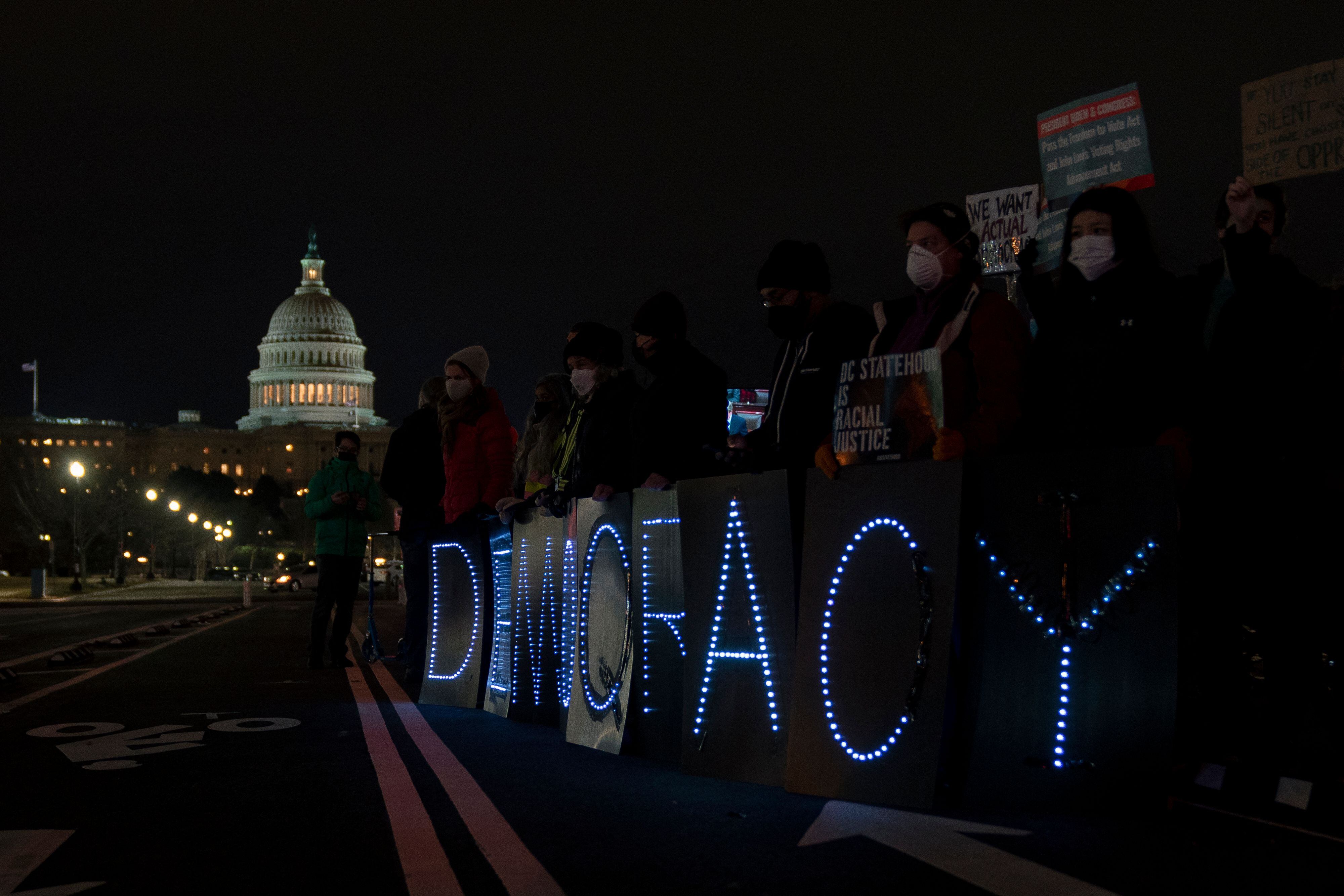 Voting rights activists hold signs near the U.S. Capitol in Washington, D.C., on January 19, 2022.