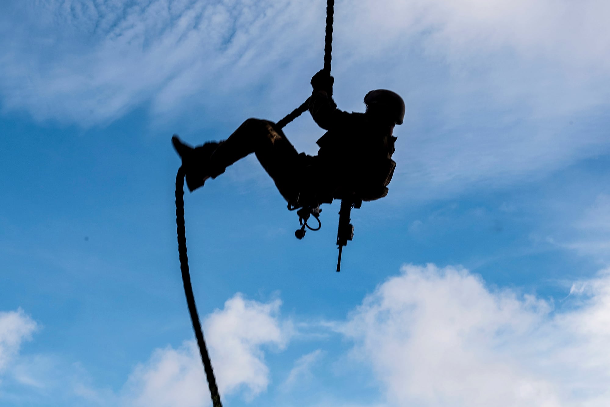 A Marine conducts fast-rope sustainment training on the flight deck of the forward-deployed amphibious assault ship USS America (LHA 6) on Aug. 23, 2020, in the Philippine Sea.