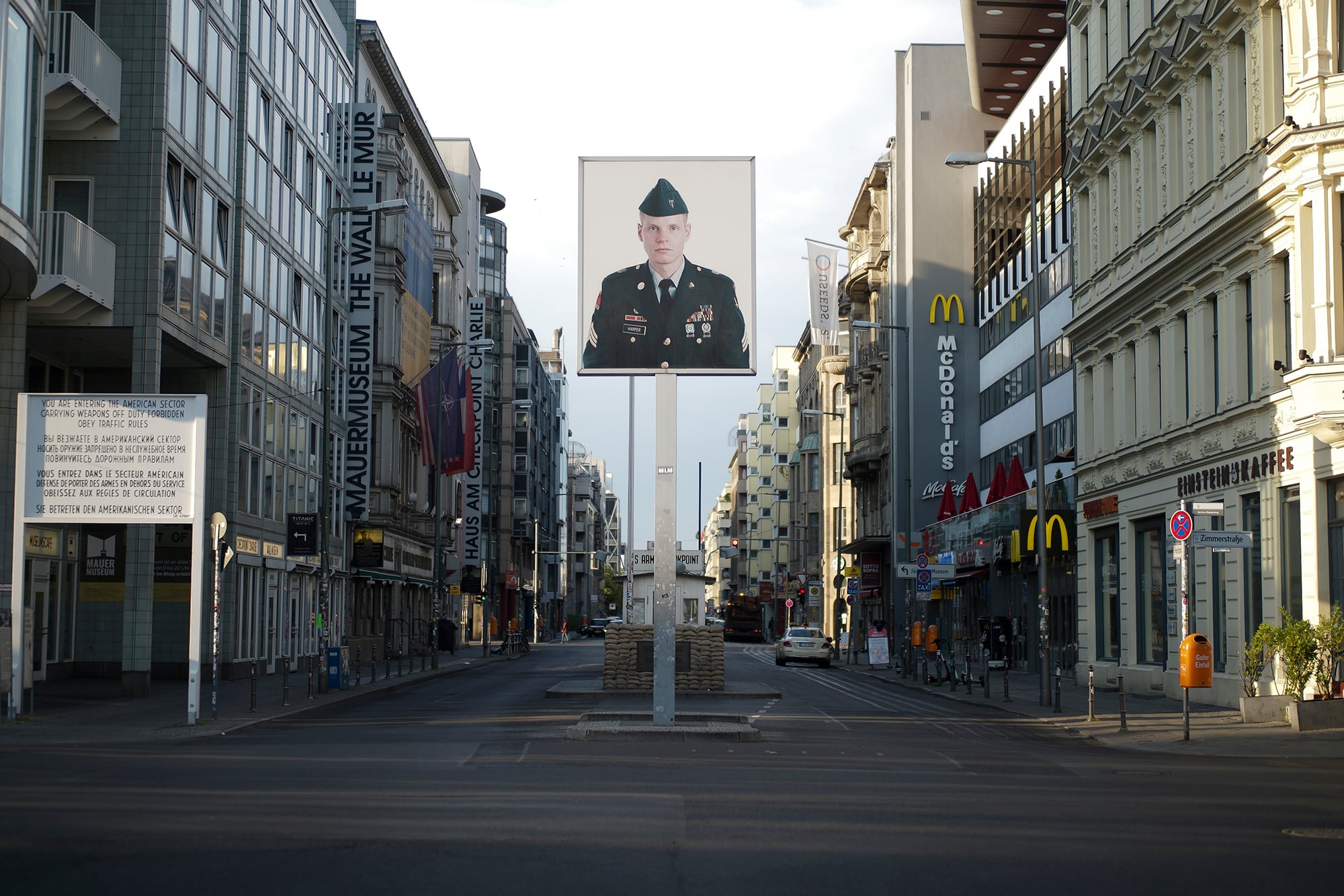 In this June 9, 2020, file photo, a picture of a former American soldier is displayed at the former U.S. Army Checkpoint Charlie in Berlin, Germany.