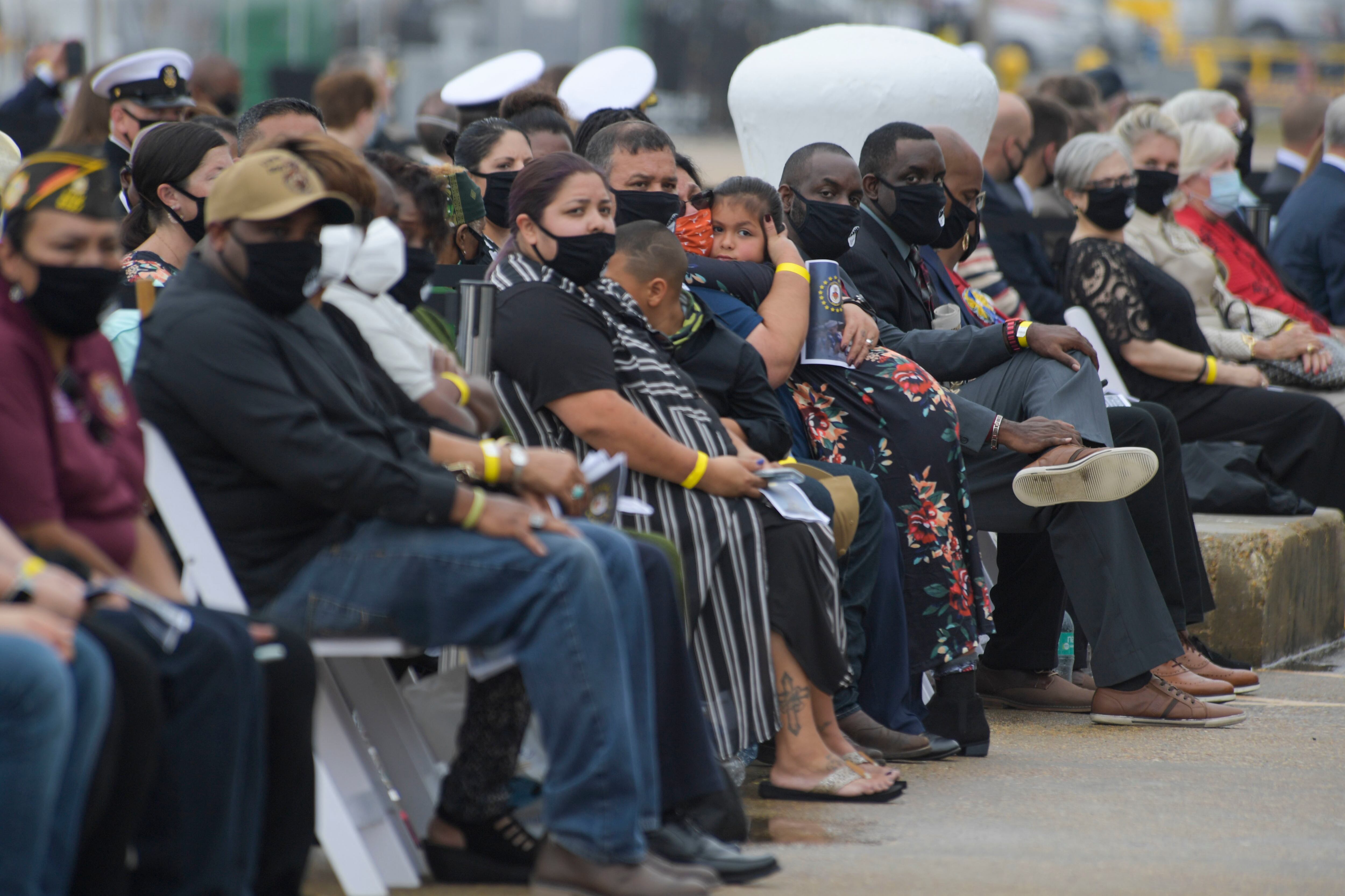 NORFOLK (Oct. 12, 2020) Gold Star families and guests watch a memorial video during the Arleigh Burke-class guided missile destroyer USS Cole (DDG 67) 20th Anniversary memorial ceremony at Naval Station Norfolk. USS Cole was attacked by terrorists at 11:18 a.m. on Oct. 12, 2000, while moored for refueling in the Port of Aden, Yemen. The explosive bomb created a 40-by-60-foot hole on the port side of the ship, and the Cole's Sailors fought fires and flooding for the following 96 hours to keep the ship afloat. Commemoration events on the 20th anniversary of the attack remember and honor the 17 Sailors who were killed, the 37 who were injured and the Gold Star families. (U.S. Navy photo by Mass Communication Specialist 2nd Class Darien G. Kenney)