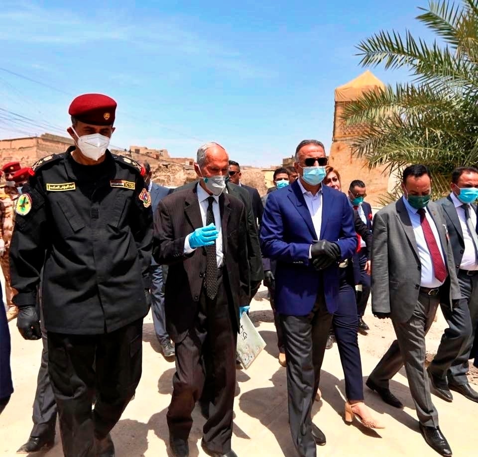 Iraqi Prime Minister Mustafa al-Kahdimi, center, visits the site of the Al–Nuri mosque, which was destroyed by Islamic State militants, during his visit to Mosul, Iraq, Wednesday, June 10, 2020.